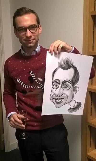 Caricaturist draws man round glasses